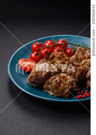 Delicious fried shish kebab of chicken or pork meat with salt, spices and herbs Delicious fried shish kebab of chicken or pork meat with salt, spices and herbs 108568832