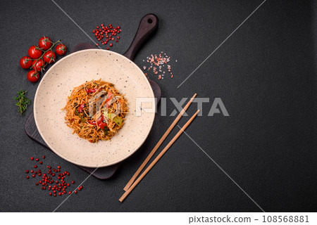 Delicious udon noodles with meat or seafood, vegetables, salt and spices 108568881