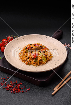 Delicious udon noodles with meat or seafood, vegetables, salt and spices 108568885