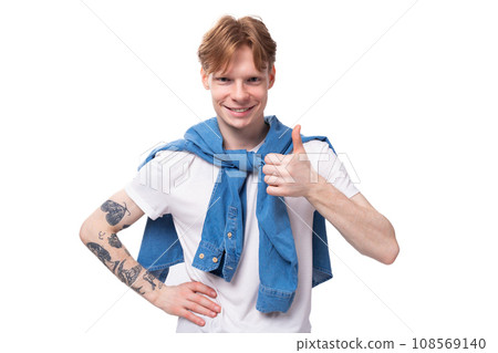 portrait of a young stylish fashionable european man with red hair and a tattoo on his arms showing portrait of a young stylish fashionable european man with red hair and a tattoo on his arms showing 108569140
