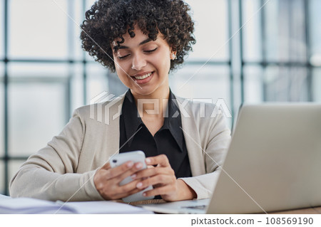 Portrait of Young Successful Caucasian Businesswoman Sitting at Desk Working on Laptop 108569190