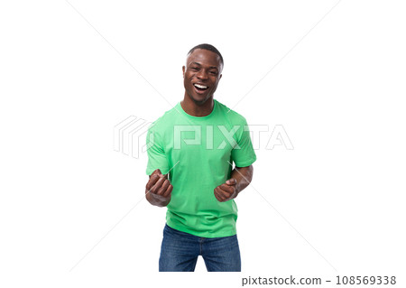 a young positive 30 year old american guy dressed casually in a basic t-shirt and jeans laughs out a young positive 30 year old american guy dressed casually in a basic t-shirt and jeans laughs out 108569338