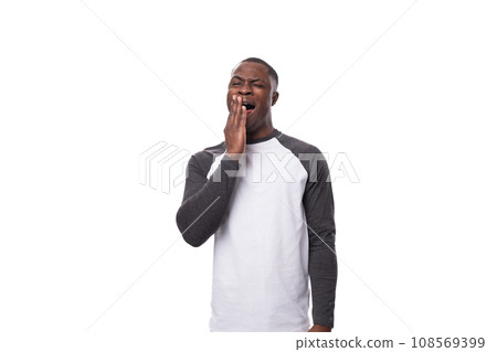 young positive african man dressed in a spring jacket on a white background with copy space young positive african man dressed in a spring jacket on a white background with copy space 108569399