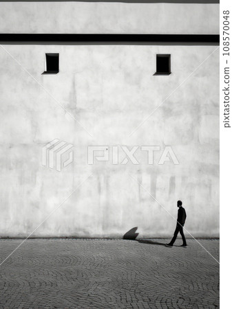 Solitary man walking beside a minimalist building with small windows. Generative AI 108570048