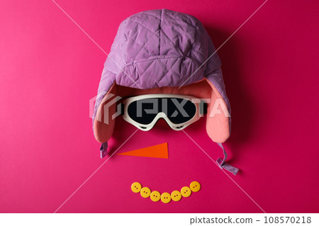 A warm hat with carrots and ski goggles A warm hat with carrots and ski goggles 108570218