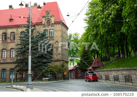 House, cars, road and trees in park outdoors House, cars, road and trees in park outdoors 108570220