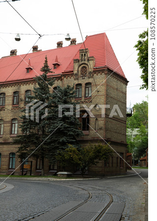 House, cars, paving stone road and trees outdoors 108570225