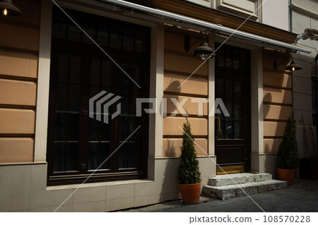 Building facade, windows and trees in flowerpots outdoors 108570228