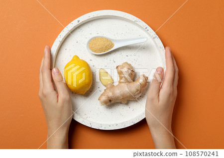 Fresh ginger root with juicy lemon in a bowl 108570241