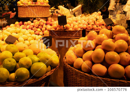 Tangerines, apples and limes in wicker baskets in supermarket Tangerines, apples and limes in wicker baskets in supermarket 108570776