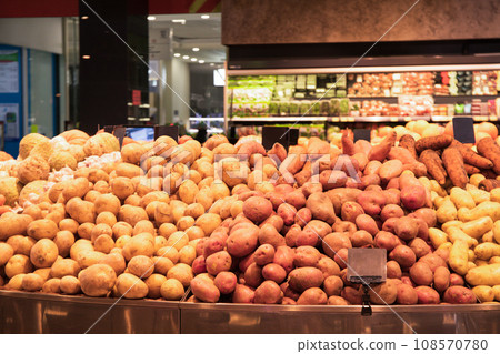 Display case with potatoes, sweet potatoes and carrots in supermarket Display case with potatoes, sweet potatoes and carrots in supermarket 108570780