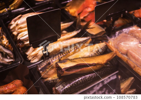 Showcase with smoked fish and price tags in supermarket Showcase with smoked fish and price tags in supermarket 108570783