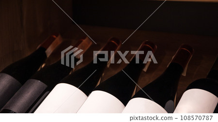 Showcase with glass bottles in supermarket, close up 108570787