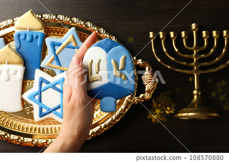 Gingerbread cookies with Jewish signs, hand and Hanukkiah on wooden background, top view Gingerbread cookies with Jewish signs, hand and Hanukkiah on wooden background, top view 108570880