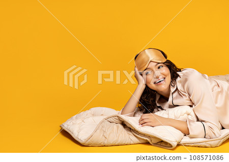 Beautiful girl in a sleeping mask and pajamas. Beautiful girl in a sleeping mask and pajamas. 108571086