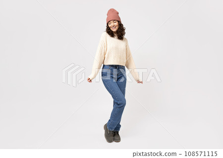 A woman in white knitted clothes on a light background. 108571115