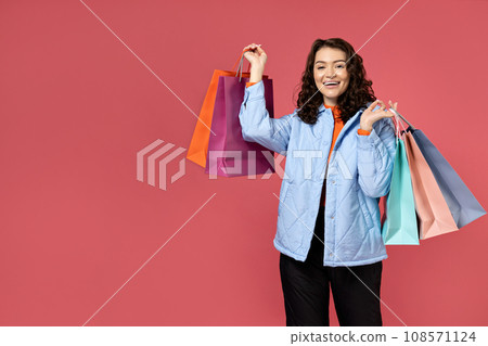 Woman with shopping bags in a jacket. Woman with shopping bags in a jacket. 108571124