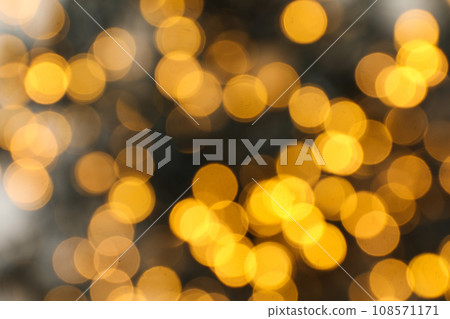 Blurred black garland with yellow lights on gray background 108571171