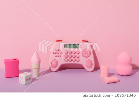Calculator, stationery and cosmetic sponge on pink background, space for text 108571340