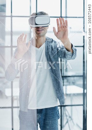Businessman using vr glasses to view educational material and financial documents Businessman using vr glasses to view educational material and financial documents 108571443