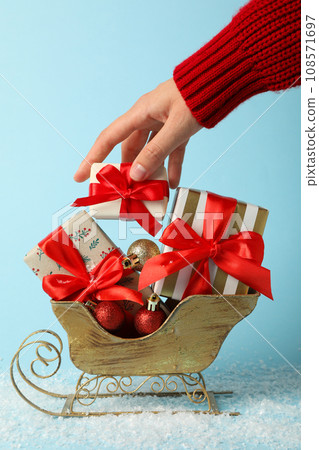Santa's sleigh with a bunch of gifts, on a blue background. Santa's sleigh with a bunch of gifts, on a blue background. 108571697