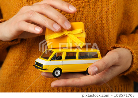 Car with New Year's gifts in hands. Car with New Year's gifts in hands. 108571703