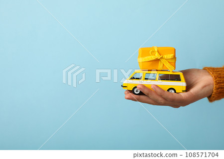 Car with New Year's gifts in hands. Car with New Year's gifts in hands. 108571704