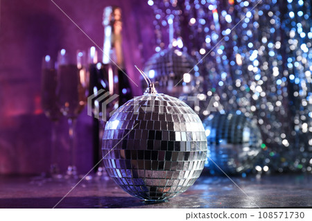 Disco ball with a bottle of shaman and glasses 108571730