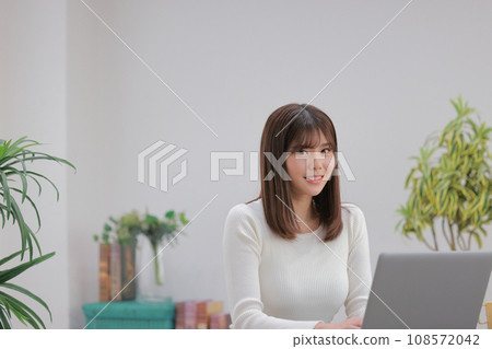 Creative woman working at a desk with her face raised 1 108572042