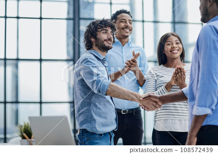 Successful Business Collaboration: Executives Greet with Handshake in Office 108572439