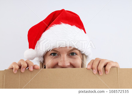 A young girl looks from behind the box A young girl looks from behind the box 108572535