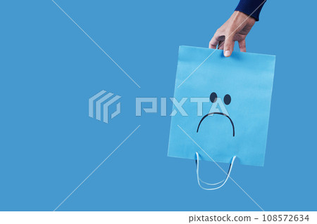 man with a sad shopping bag upside-down man with a sad shopping bag upside-down 108572634