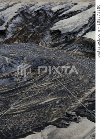 Kamaiso coast flowing water and black sand art Kamaiso coast flowing water and black sand art 108573180
