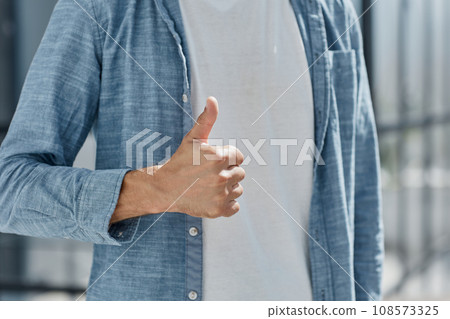 portrait and thumbs up for success standing at modern office 108573325