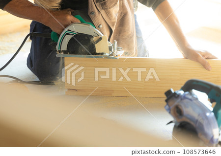 A man who works as a carpenter using wood A man who works as a carpenter using wood 108573646