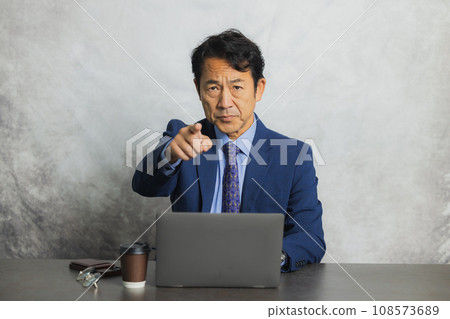Businessman, middle-aged man, using a computer Businessman, middle-aged man, using a computer 108573689