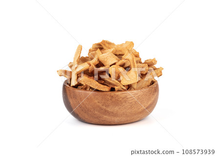 Wooden bowl full of dried apples on a white background. Wooden bowl full of dried apples on a white background. 108573939
