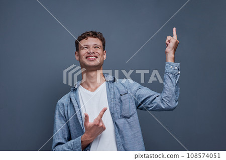 A man on a gray background shows aside 108574051