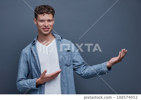A man on a gray background shows aside 108574052