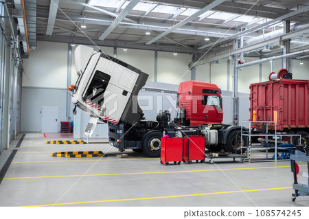 Servicing and repairing trucks in a large garage. Car service and truck maintenance. Servicing and repairing trucks in a large garage. Car service and truck maintenance. 108574245