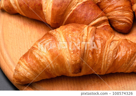Fresh croissants on a wooden background. French pastries 108574326
