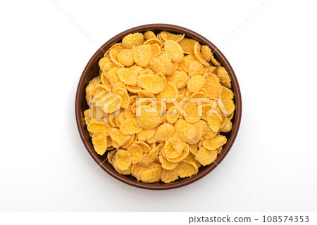 A plate of corn flakes in a plate on a white background 108574353