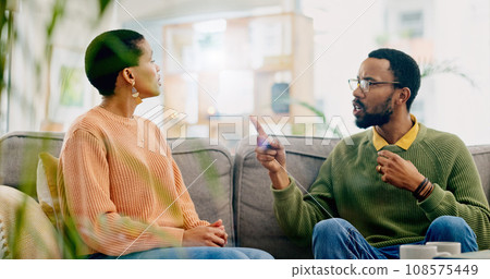 Fight, couple and home with marriage stress, frustrated and angry man on a living room sofa. Mistake, yelling and conversation of people with argument, fail and conflict with divorce discussion 108575449