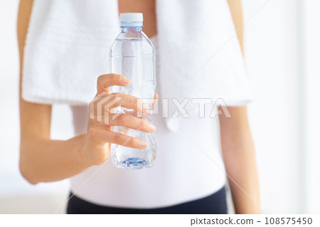 Water bottle, hands or woman with health, fitness or wellness for hydration after exercise or training. Thirsty sports person, closeup or healthy athlete with liquid or aqua after workout to relax 108575450