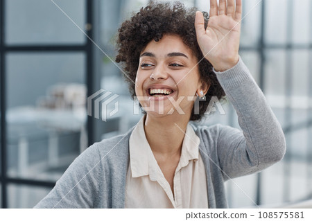 woman in the office greeting her colleagues woman in the office greeting her colleagues 108575581
