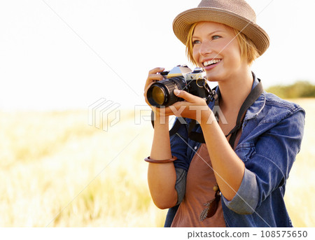 Field, photographer and woman with a camera, adventure and thinking with ideas, nature and memory. Person, countryside and girl with photography, tourism and journey with sunshine, smile and travel Field, photographer and woman with a camera, adventure and thinking with ideas, nature and memory. Person, countryside and girl with photography, tourism and journey with sunshine, smile and travel 108575650