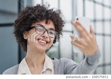 Using mobile phone at work, taking break. Using mobile phone at work, taking break. 108575651