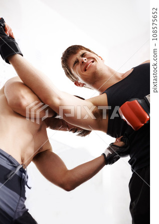 Men, martial arts and fitness, fight and pain in competition, MMA and battle with power and athlete in gym. Exercise, combat sport and boxing with strong boxer and training with punch and injury Men, martial arts and fitness, fight and pain in competition, MMA and battle with power and athlete in gym. Exercise, combat sport and boxing with strong boxer and training with punch and injury 108575652