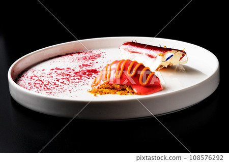 Italian Sicilian cannolo dessert closeup on white plate macro with crust and ricotta cheese 108576292