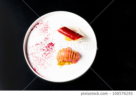 Italian Sicilian cannolo dessert closeup on white plate macro with crust and ricotta cheese 108576293